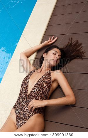Photo Of Beautiful Girl With Long Dark Hair In Leopard Print Bikini Relaxing Beside Swimming Pool, H