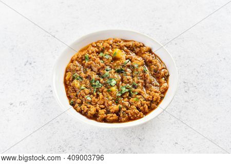 Keema Curry In Bowl Over Light Stone Background With Copy Space. Indian And Pakistani Style Dish. Cl