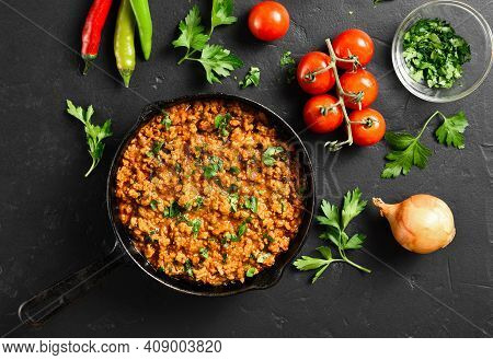 Keema Curry In Frying Pan Over Black Stone Background. Indian And Pakistani Style Dish. Top View, Fl