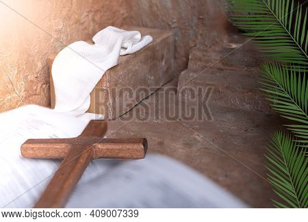Palm Leaves On A Empty Tomb And Wooden Cross Over Open Bible Background With Copy Space For Inscript
