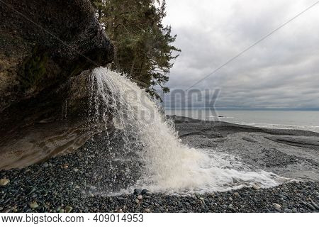 Waterfall On The Rocky Coast At Sandcut Beach On Vancouver Island, Canada
