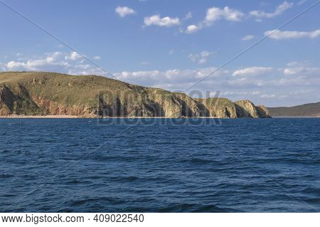 View From The Japanese Sea Of Beautiful Rugged Cliffs Of Popovs Island On Sunny Day