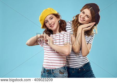 Fashion Sisters In Hats Fun Lifestyle Blue Background Studio