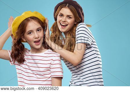 Fashion Sisters In Hats Fun Lifestyle Blue Background Studio