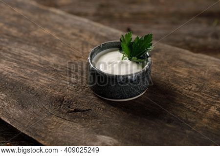 Sour Cream Or Yogurt In Bowl On Wooden Background. Cooking Concept. Close-up.