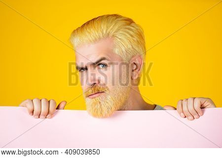 Serious Man Holding Empty Placard Board For Media Banner. Sale. Surprised Bearded Man Holding Empty 