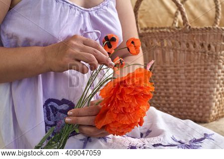 Woman In Blue Dress Holding Poppe Flowers, Close Up On Her Hands. Spring Time Dreams.