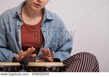 Young Faceless Caucasian Woman Playing Small Ethnic Drums