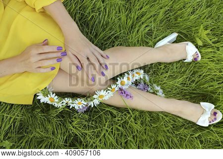 Manicure And Pedicure Design With A Matte Lilac Coating On A Girl Sitting On The Green Grass With A 