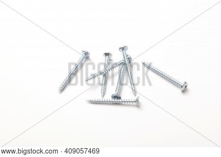 Group Of Screws On A White Background.