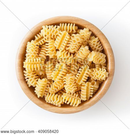 Uncooked Radiatori Pasta In Wooden Bowl Isolated On White Background With Clipping Path
