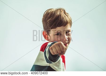 Portrait Of Young Boy In Warior Pose Holding Fists