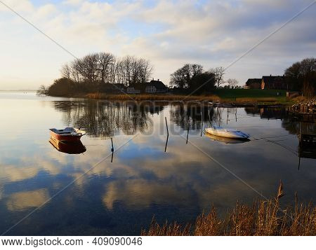 Magical Tranuil Beautiful With Clear Calm Water Sunset With Great Clouds Formation By The Sea Shore 