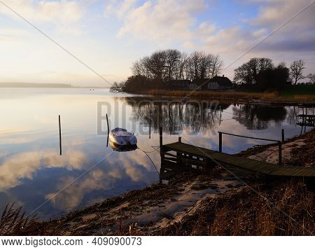 Magical Tranuil Beautiful With Clear Calm Water Sunset With Great Clouds Formation By The Sea Shore 