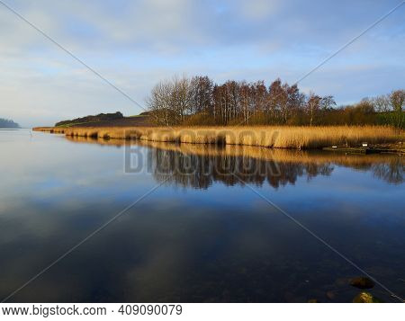Magical Tranuil Beautiful With Clear Calm Water Sunset With Great Clouds Formation By The Sea Shore 