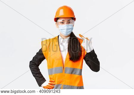 Covid-19 Safety Protocol At Enterpise, Construction And Preventing Virus Concept. Confident Asian Fe