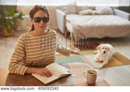 Warm Toned Portrait Of Modern Blind Woman Reading Braille Book While Sitting At Table In Cozy Home I