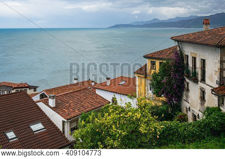 Colorful Houses Against Seascape Backdrop. Picturesque Coastal Landscape. Small Fishing Village Of L