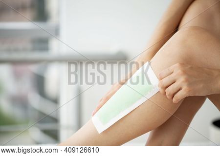 Woman Uses Wax Tape To Remove Hair On Legs
