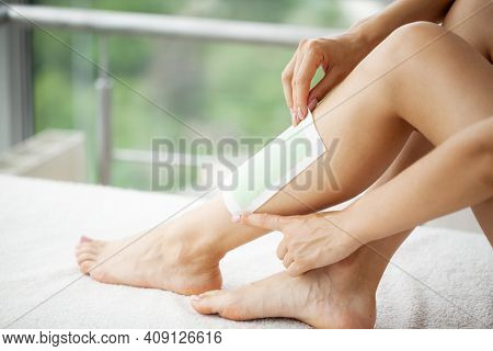 Woman Uses Wax Tape To Remove Hair On Legs