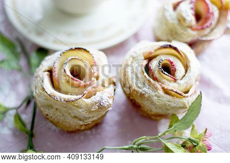 Apple Strudel In Rose Shape And Floral Decoration On Pink Background. Rose Shaped Apple Baked Desser