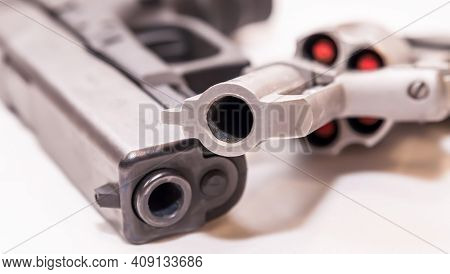 Two Handguns, A Black 9mm Pistol And A Stainless 44 Spl Revolver Loaded With Red Tipped Hollow Point