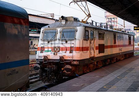 Picture Of A Locomotive Engine Is Wating For Connecting With A Passenger Train At A Junction Railway