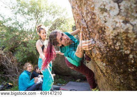 Friends Go In For Sports In Nature, Bouldering On Rocks, Girl Climbs A Big Stone, Woman Is Belayng P