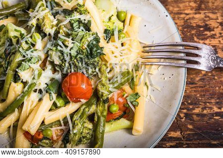 Vegetarian American And Italian Primavera Pasta Dish With Broccoli, Beans, Asparagus, Peas And Tomat