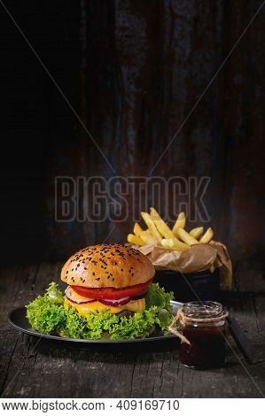 Elicious Burger With Sauce. Hamburger. Delicious Grilled Angus Burger With Cheese, Salad And Tomatoe