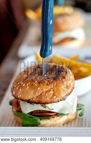 Elicious Burger With Sauce. Hamburger. Delicious Grilled Angus Burger With Cheese, Salad And Tomatoe