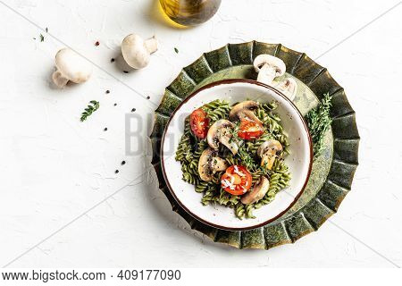 Vegetarian Vegetable Green Pasta Spinach Leaves And Cherry Tomatoes On Liht Background. Pasta Vegan 