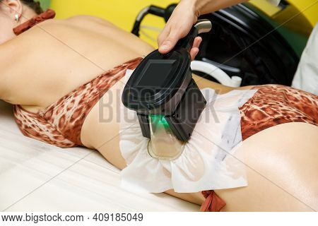 Woman Getting Cryolipolysis Fat Treatment Procedure In Beauty Salon
