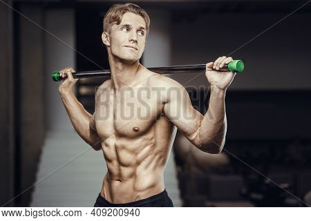 Fitness Man At Workout In Gym With Bodybar Stretching Muscles. Workout Fitness And Bodybuilding Heal