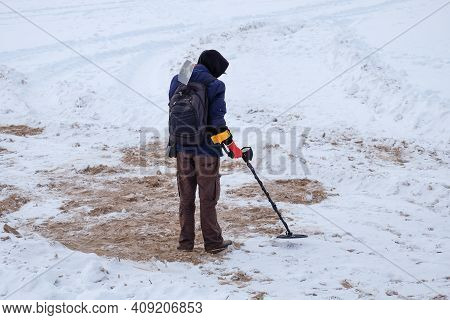 Treasure Hunter Is Looking For Treasures With A Metal Detector.