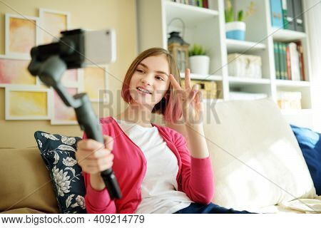 Beautiful Teenage Girl Recording Video Blog With Her Smartphone. Young Vlogger Shooting Vlog At Home