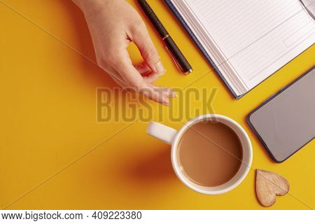 Work From Home. Blank Notepad, Coffee Cup And Pen On Wood Table. Flat Lay Top View Copy Spce.
