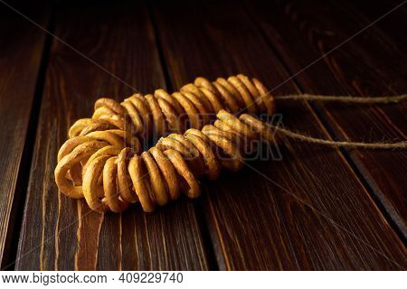 Bagels On A Rope On Dark Wooden Table. Traditional Russian Food.
