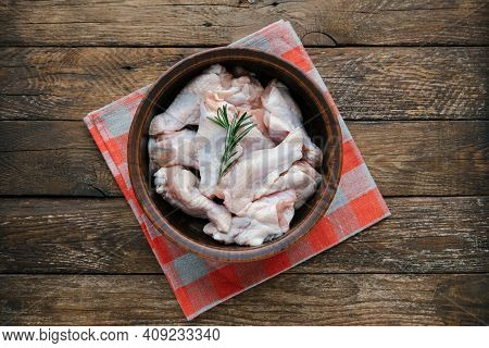 Raw Chicken Wings In The Bowl Prepare For Cooking. Fresh Uncooked Drumette Or Drumstick With Rosemar