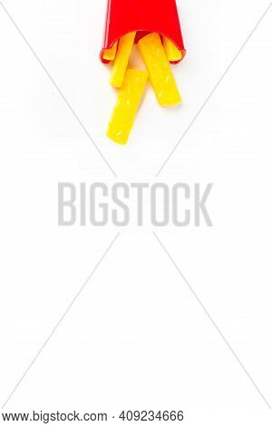Miniature Potato Fried Model Falls From Top. Small Model Of French Fries On White Background. Creati