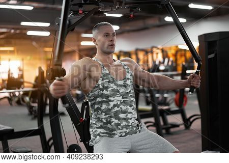 Muscular Athletic Bodybuilder Sitting Bench Training Chest Muscles On Fitness Equipment Pec Deck Fly