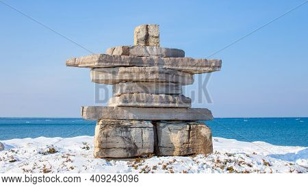 A Giant Inukshuk Stands Overlooking Georgian Bay At Collingwood's Sunset Point Park. A Monument In T