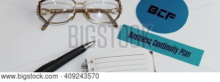 Paper With Words Bcp Business Continuity Plan. Nearby Are Glasses, A Pen And A Notepad.