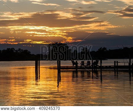 Dock And Chairs During Sunset Over Glebe Creek