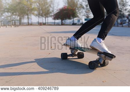 Close-up And Motion Movement Asian Women Surf Skate Or Skateboard Outdoors On Beautiful Morning. Hap