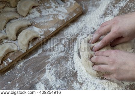 Woman Hands Kneading Doung With Fingers, Flour, Vareniki, Traditional Russian Dish At Kithen Table, 