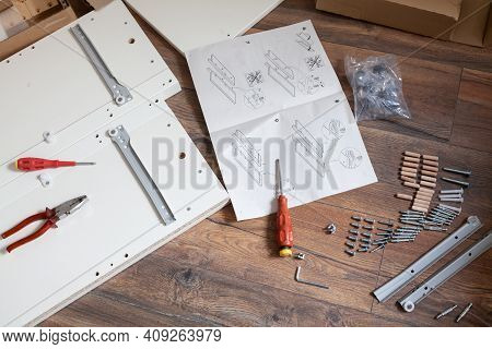 Furniture Assembly Parts And Tools For Self Assembly Furniture, On The Floor.