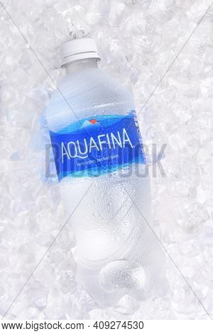 IRVINE, CALIFORNIA - JANUARY 22, 2017: Aquafina Water Bottle on ice. The purified water brand is produced by PepsiCo, in both flavored and unflavored varieties.