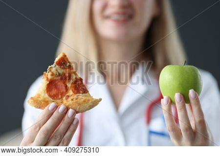 Nutritionist Holding Pizza And Green Apple In His Hands Closeup. Healthy Diet Concept