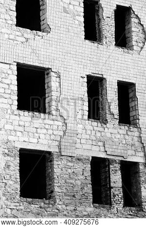 Black And White Wall Of Old Destroyed House With Broken Windows